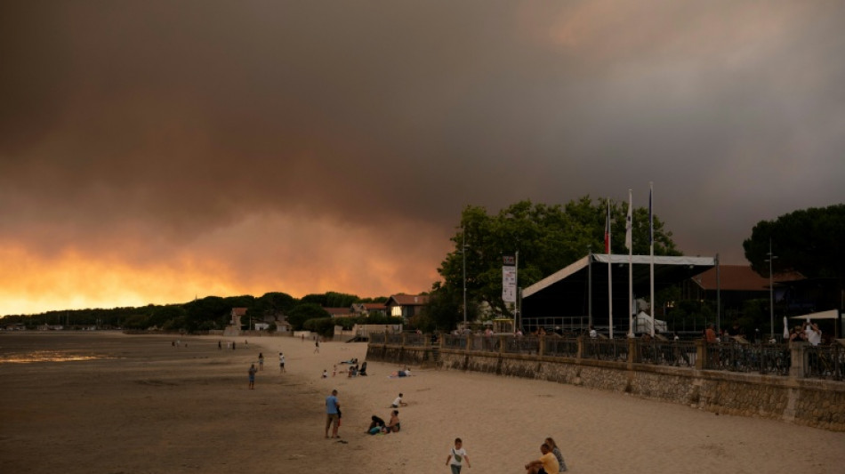 Tens of thousands in France flee burning holiday haven, by road and sea